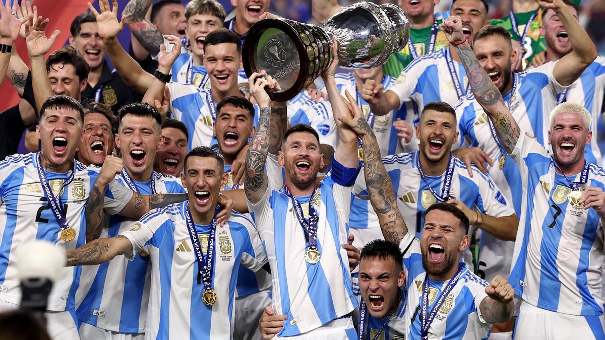 Argentina’s Lionel Messi lifts the trophy as he celebrates with teammates after winning Copa America 2024